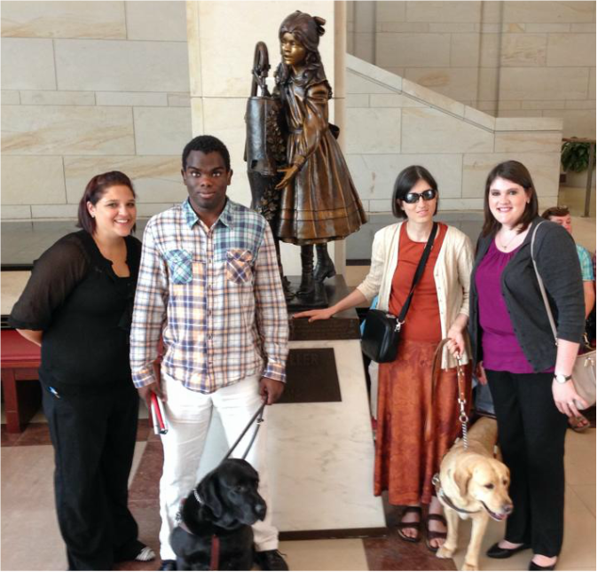 Two DBCA member with two volunteer interpreters member standing in front of the Helen Keller statue 
